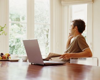 man with laptop and phone